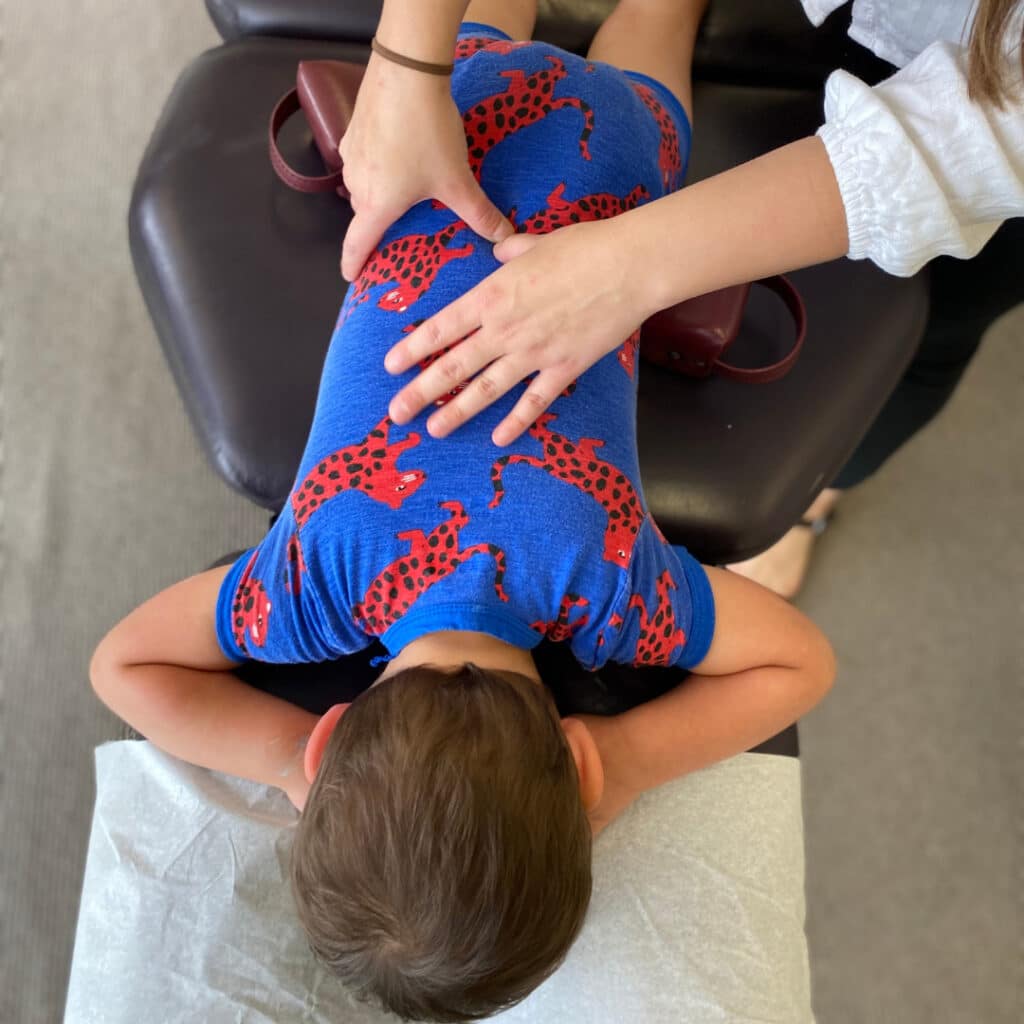 A photo of a toddler being adjusted by a Paediatric Chiropractor Perth | Carlin Chiropractic